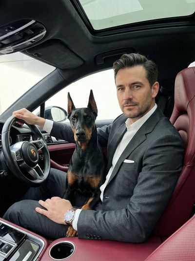 Dominance in Luxury: Man and Doberman in a Porsche