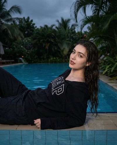 Moody Tropical Vibes: A Relaxed Portrait by the Pool